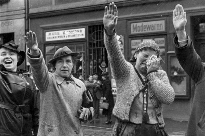 Mujeres saludando a tropas nazis en 1938